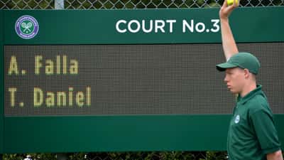 Wimbledon grass tennis courts sign 'It all starts here' at the Championships