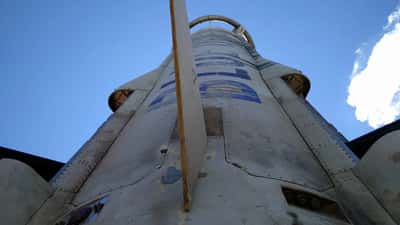 Blue Origin New Shepard rocket on launch pad with capsule visible