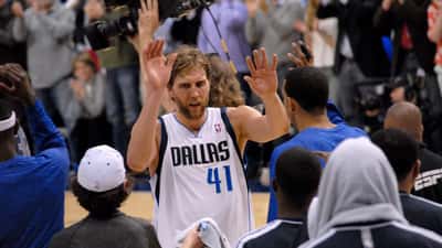 Dirk Nowitzki high-fiving fans during a 2013 NBA game