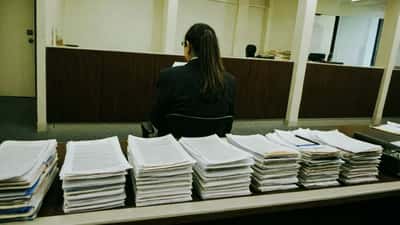 Legal professional reviewing documents at a Melbourne tribunal hearing room