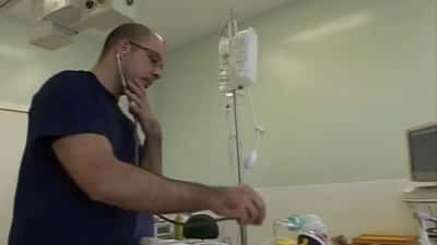 Cardiologist in hospital reviewing patient cardiac chart and echocardiogram results