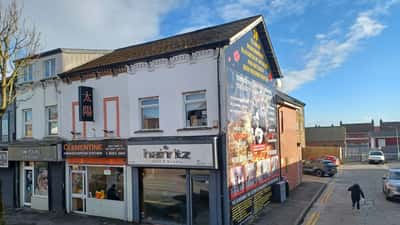 Period commercial buildings at 156, 158 and 160 Shankill Road in Belfast, Northern Ireland