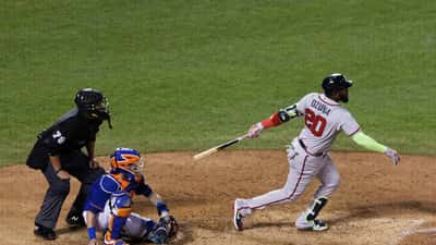 Marcell Ozuna swinging at a pitch in an MLB baseball game