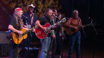 Willie Nelson performing live on stage with Jamey Johnson at country music concert