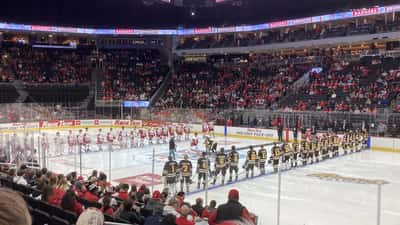 Wisconsin Badgers ice hockey players during pre-game ceremonies at a college arena