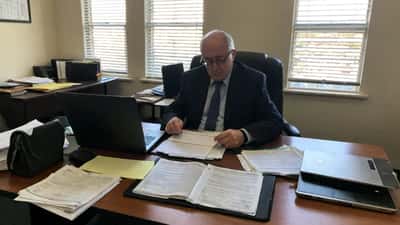 Immigration lawyer reviewing visa documents and Australian Home Affairs paperwork in a Sydney office