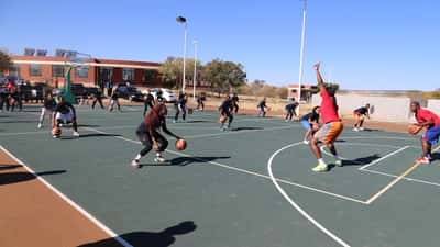 WNBA player demonstrating basketball at a youth coaching clinic, representing professional athlete employment