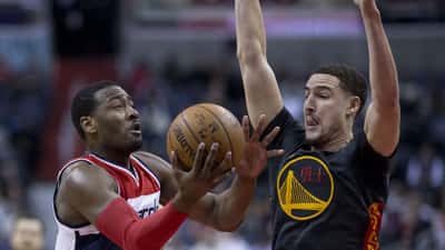 Klay Thompson and John Wall in NBA game action