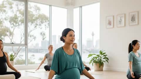 Pregnant Australian woman in Butterfly Pose on a yoga mat at a Sydney prenatal yoga studio