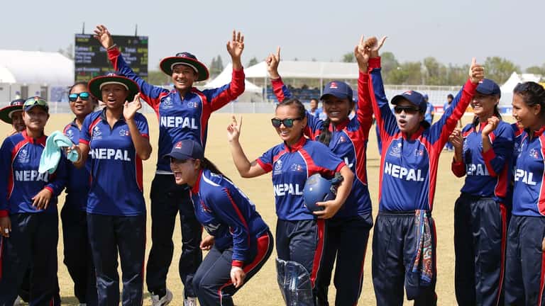 Japan women's cricket players at an Asian Games match, competing on the field during international tournament play
