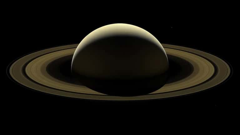 Hubble Space Telescope image of Saturn with its rings backlit against the darkness of space