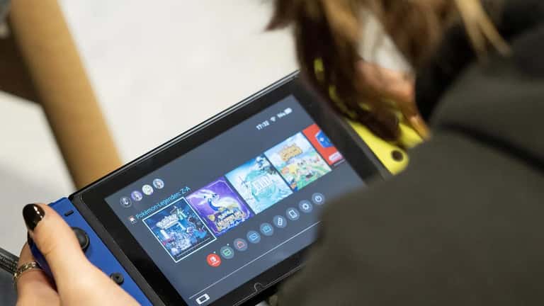 Person playing a Nintendo Switch 2 handheld gaming console