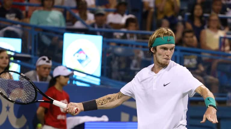 Andrey Rublev in action on a tennis court at a professional ATP tournament