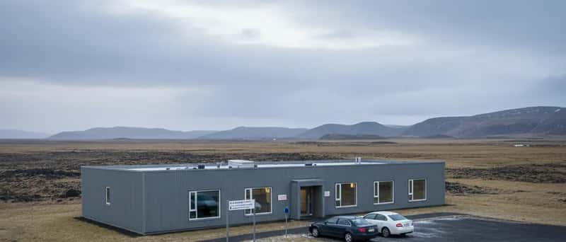 Exterior of a typical Icelandic health centre with corrugated metal cladding and an overcast sky