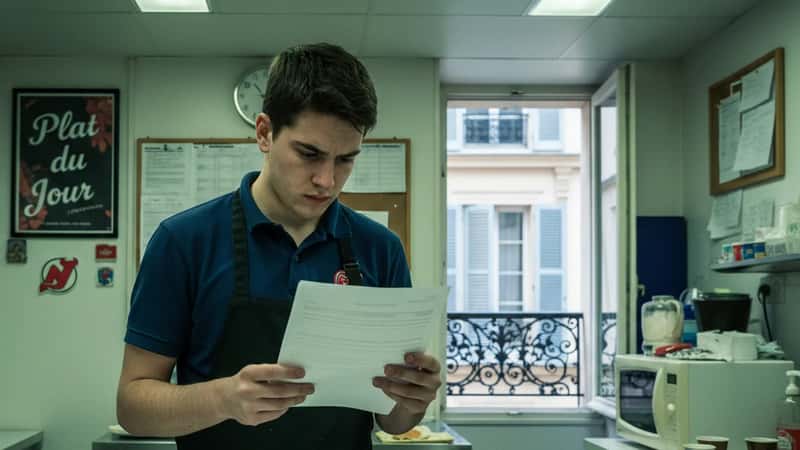 New Jersey restaurant worker checking payroll notice posted in break room, minimum wage compliance