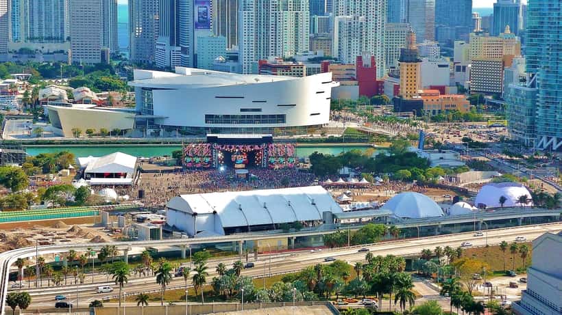 Crowd at Ultra Music Festival with stage lights and speakers, electronic music event