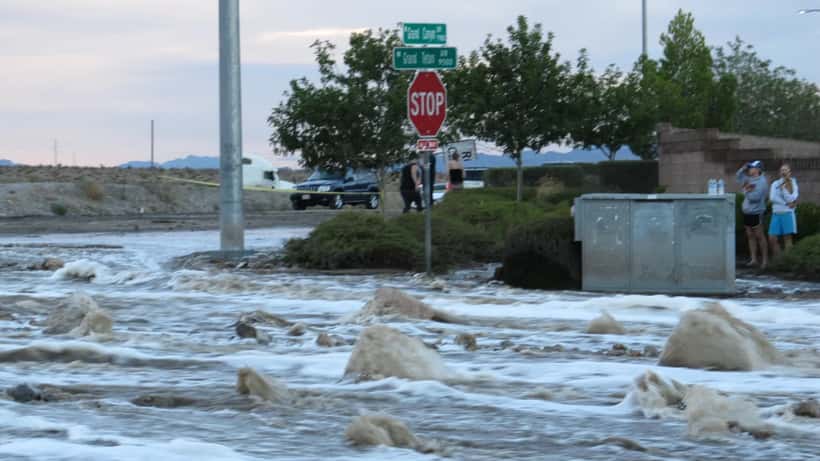 Flooded street in Las Vegas Nevada with stormwater rushing between residential buildings