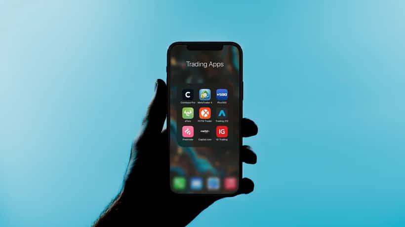 Trading apps displayed on an iPhone screen showing financial market data
