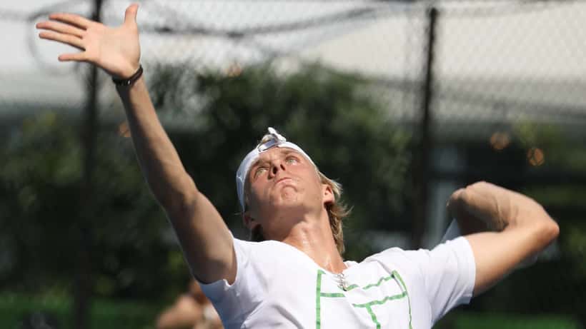 Denis Shapovalov serving during a professional tennis match