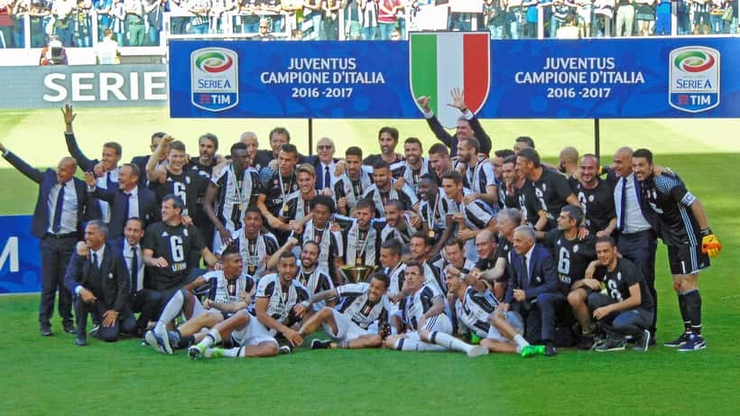 Juventus FC celebrating Serie A title, players in black and white kit on pitch