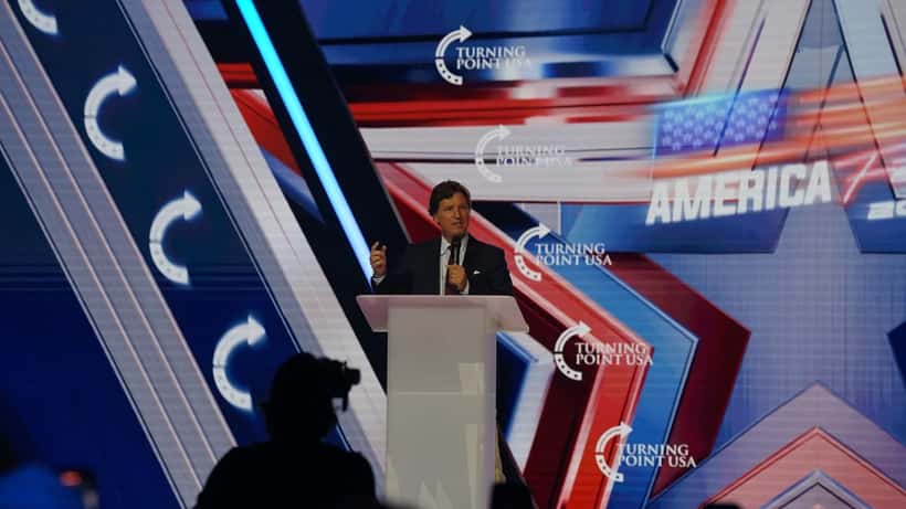 Tucker Carlson en conférence à AmericaFest 2025