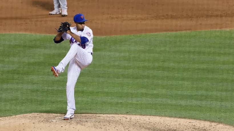 Edwin Díaz pitching in a baseball game, arm extended mid-delivery on the mound