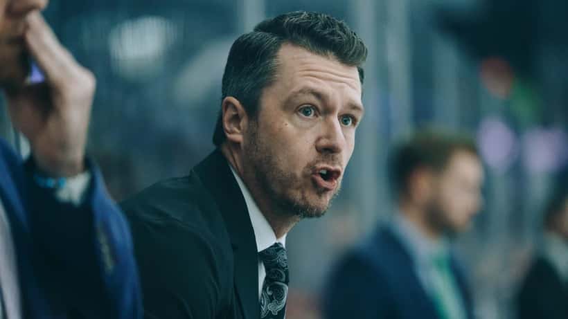 Jääkiekkovalmentaja ohjaa joukkuettaan vaihtoaitiosta SM-liigaottelussa