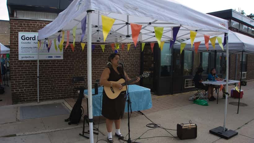 Emerging UK singer-songwriter performing on stage with guitar