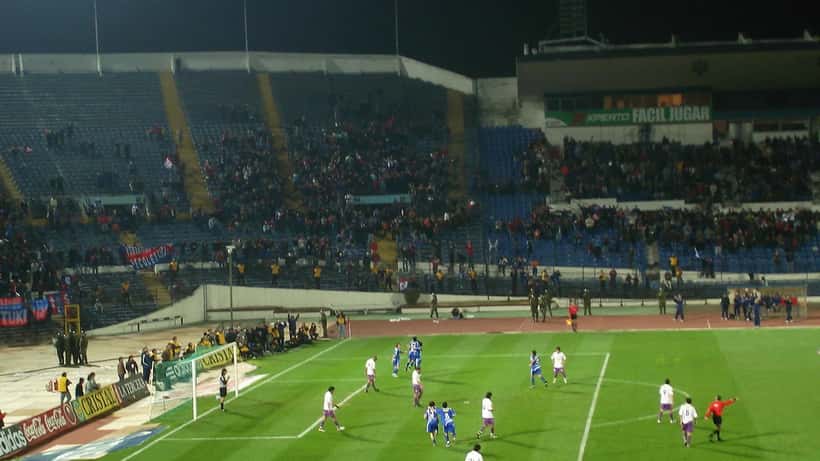 Chilean football match with players competing on a South American pitch