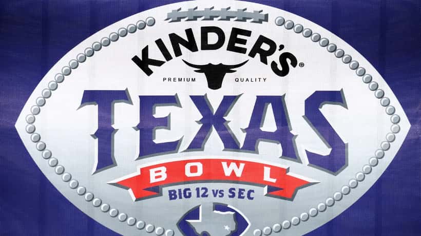 Texas college football game atmosphere with crowd and players on field representing the NIL compensation divide between FCS and FBS programs in 2026