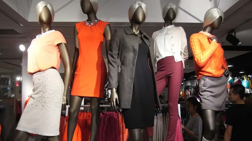 H&M store front with sustainability clothing labels, consumer rights documents