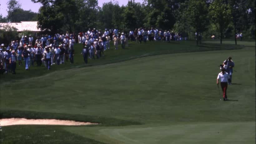 Golfer playing in a PGA Tour tournament with spectators watching from the gallery