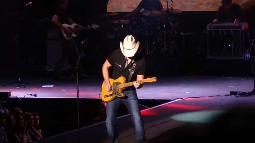 Brad Paisley performing at an outdoor concert event with guitar