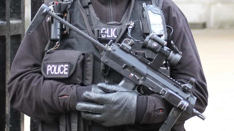 Armed police officers in tactical gear on a UK street