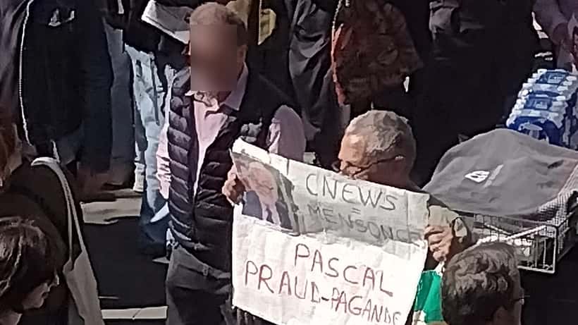 Avocat français consultant des documents juridiques sur la réglementation des médias audiovisuels dans un bureau parisien