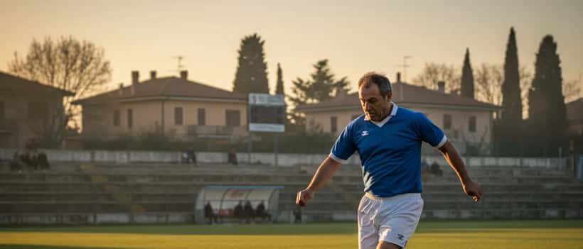 Calciatore amatoriale italiano di mezza età in azione su campo da calcio