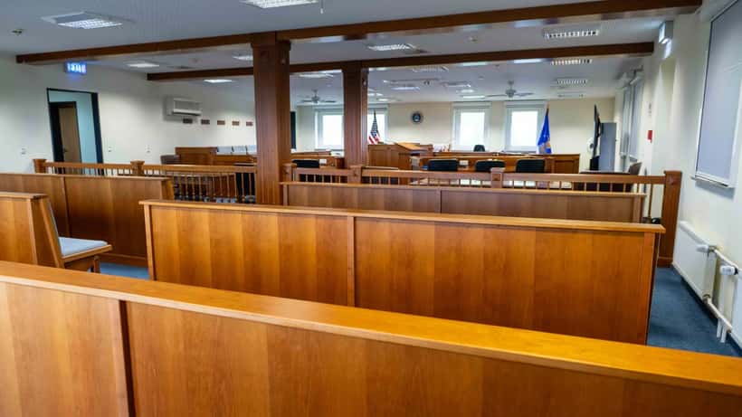 Empty courtroom interior with wooden benches and legal furnishings representing a family court hearing
