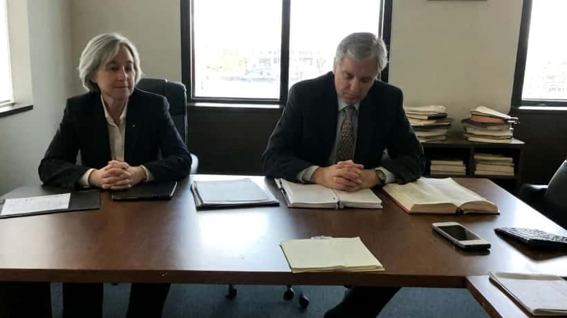 Canadian family lawyer consulting with client about divorce documents and dating app evidence in a Toronto law office