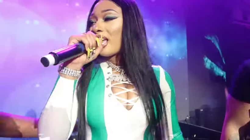 Megan Thee Stallion performing live on stage under spotlights