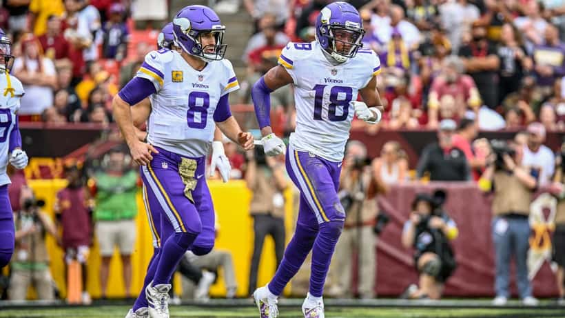 Kirk Cousins and Justin Jefferson on the field during an NFL game
