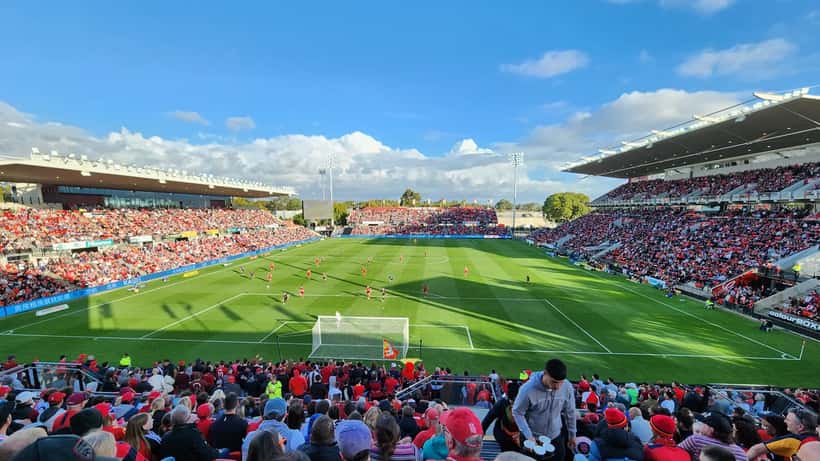 Adelaide United football players competing at Hindmarsh Stadium in a match