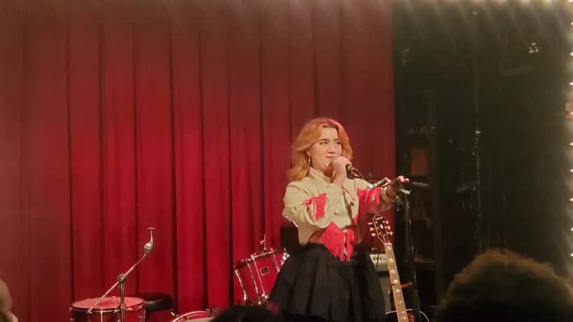 Irish singer-songwriter CMAT performing live, photographed in Brooklyn before her 2026 Ivor Novello win for Best Album