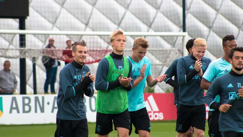 Ajax-spelers tijdens een openbare training, met aandacht voor blessurepreventie in het profvoetbal