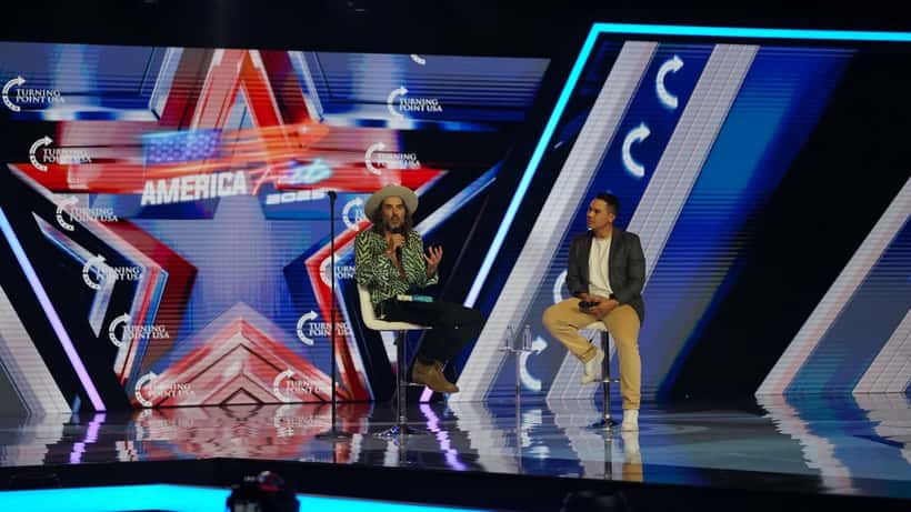 Russell Brand speaking at AmericaFest 2025 conference
