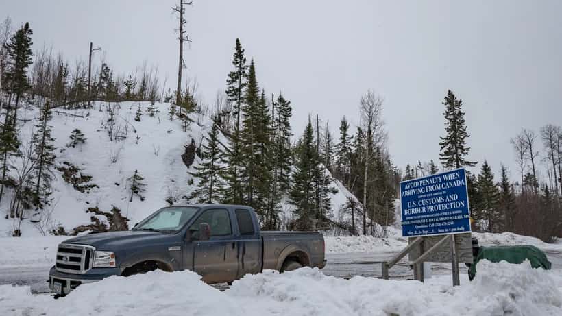 US-Canada remote border crossing sign on a rural road