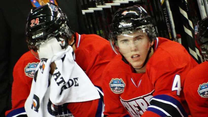 Young hockey player in Team Canada jersey competing at U18 international tournament at Rogers Place Edmonton