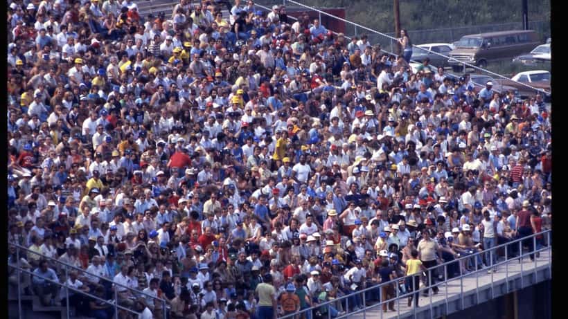 Baseball stadium crowd at a minor league ballpark, viewed from behind home plate