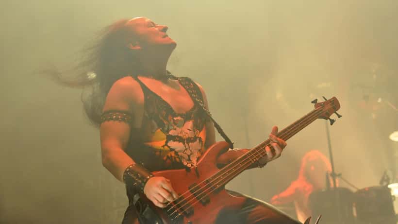 Conrad Cronos Lant performing on stage with Venom at a heavy metal festival