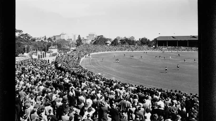 AFL players in action on an Australian rules football oval, representing sports longevity and health 2026
