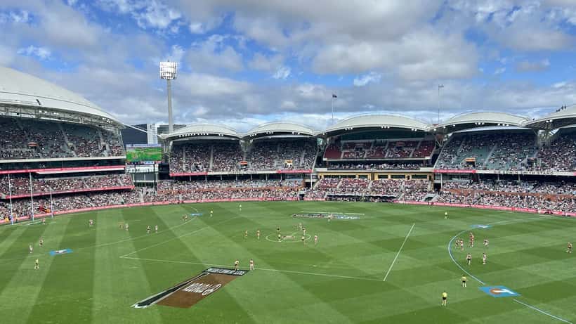 Adelaide Crows AFL players competing on the field during a round 1 match